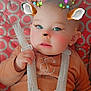 Keyden participe au concours pour gagner de l'argent avec cette photo : baby, blue_eyes, car_seat, child, clothing, cute, digital_filter, face, filter, glowing_lights, hand, indoor, infant, lights, orange_outfit, patterned_background, pink_circles, reindeer_antlers, reindeer_ears, safety_harness