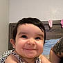 Sonia is registered to the contest to win money with this photo: arm, baby, bed, bedding, child, clothing, cute, face, happy, headboard, human, indoor, infant, lying, person, portrait, skin, smiling, tattoo, young