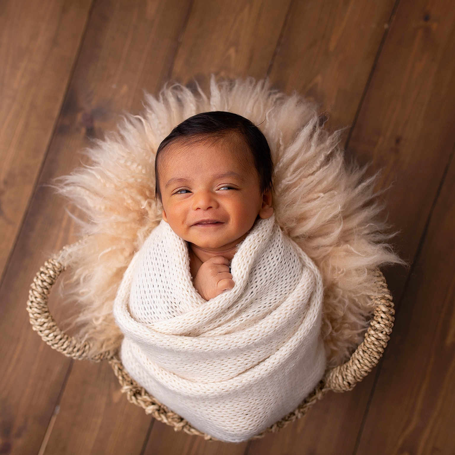 Suhail is registered to the contest to win money with this photo: baby, basket, blanket, child, cozy, cute, fur, indoors, infant, knit, newborn, peaceful, portrait, resting, sleepy, smiling, soft_texture, warm, wooden_floor, wrapped