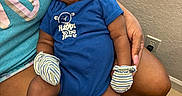 Kashton joined the competition — help win amazing prizes! arm, baby, blue_onesie, clothing, comfort, cute, hand, home, indoor, infant, natural_light, person, portrait, relaxed, sitting, skin, sleeping, striped_mittens, striped_socks, window
