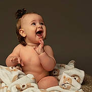 Amelia joined the competition — help win amazing prizes! animal_print, baby, background, blanket, child, clapping, cute, expression, face, hair, hand, happy, indoors, infant, portrait, sitting, skin, smiling, toddler, warm_colors