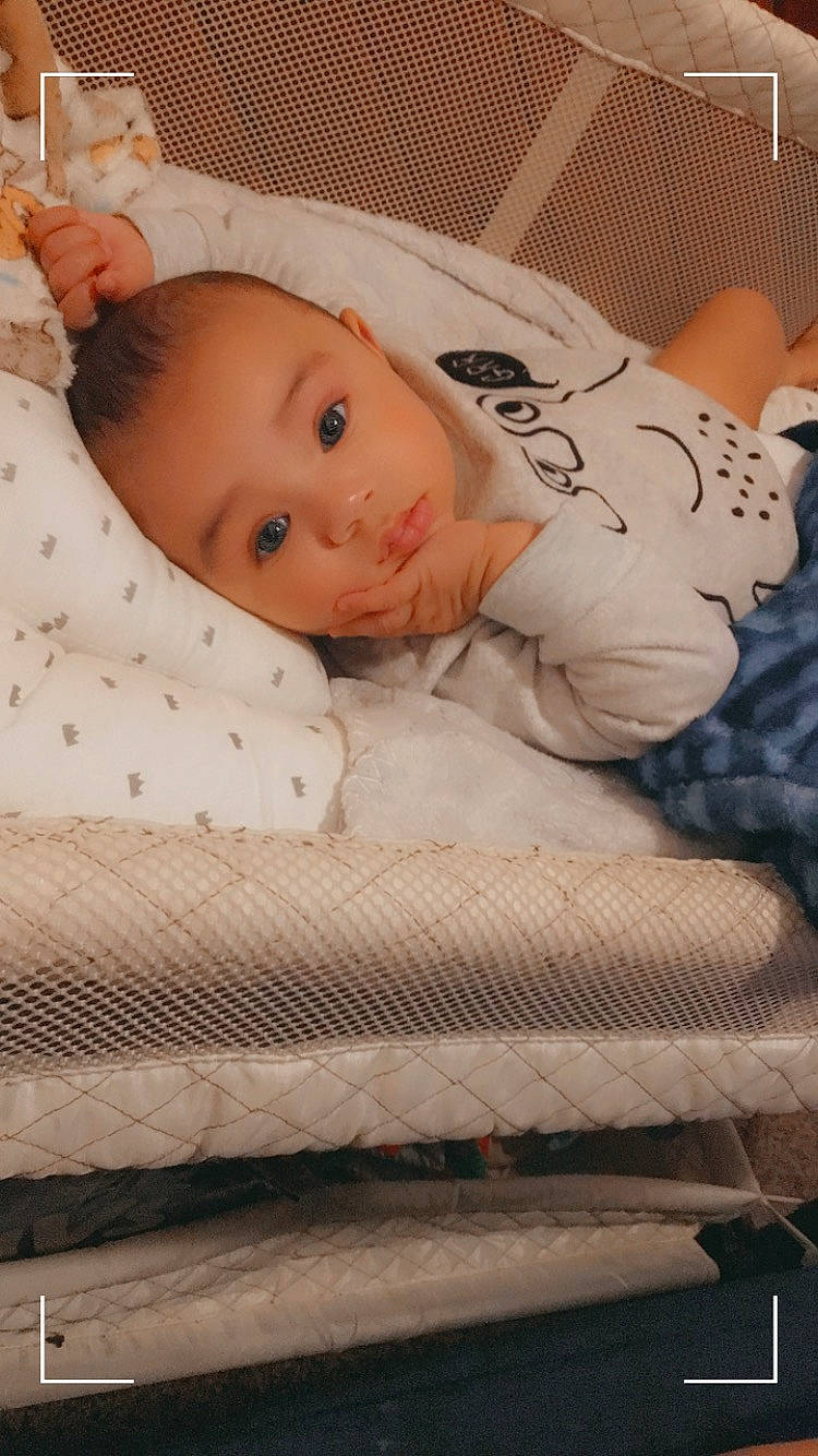 Dj is registered to the contest to win money with this photo: baby, baby_products, baby_safety, baby_toddler_clothing, bedding, bedtime, cheek, child, comfort, face, flooring, head, linens, pattern, person, room, skin, sleeve, textile, toddler