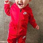 Swan a rejoint le concours — aidez-le/la à gagner de superbes lots ! child, toddler, smiling, red_sportswear, nike, jacket, pants, sneakers, standing, happy, indoor, floor, tile, wall, cute, person, clothing, portrait, fashion, casual