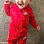 child, toddler, smiling, red_sportswear, nike, jacket, pants, sneakers, standing, happy, indoor, floor, tile, wall, cute, person, clothing, portrait, fashion, casual