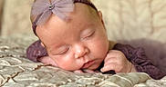 Meilani joined the competition — help win amazing prizes! baby, sleeping, headband, bow, infant, closeup, soft, blanket, resting, peaceful, cute, portrait, child, newborn, purple, texture, face, hand, toddler, cozy