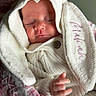 Maliah joined the competition — help win amazing prizes! baby, newborn, sleeping, knitted_blanket, white_clothing, hood, hand, face, peaceful, soft_texture, cozy, infant, portrait, close_up, fabric, pink_flower_pattern, cute, child, wrapped, resting
