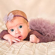 Maliah joined the competition — help win amazing prizes! baby, infant, face, headband, purple_clothing, tulle, blanket, bed, cute, portrait, newborn, sleepwear, hand, skin, eyes, expression, soft_light, indoor, child, resting