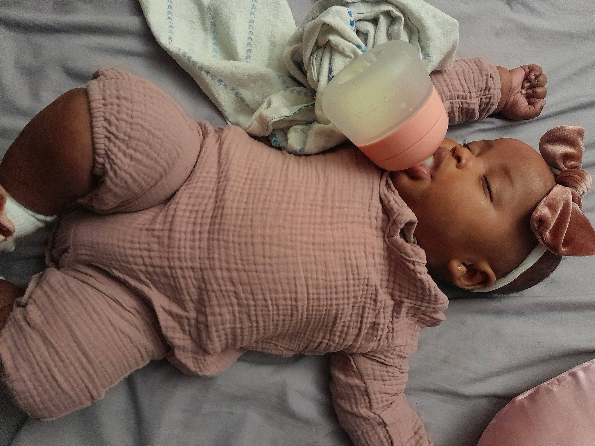 Amirah is registered to the contest to win money with this photo: abdomen, baby, baby_products, baby_sleeping, baby_toddler_clothing, chest, comfort, gesture, glasses, hand, happy, human_body, human_leg, joint, knee, leg, linens, person, thigh, toddler