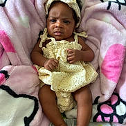 Legaci Velazquez joined the competition — help win amazing prizes! baby, infant, child, yellow_dress, headband, blanket, pink, soft_texture, cartoon_pattern, legs, feet, hands, expression, indoor, portrait, cute, person, newborn, resting, cozy