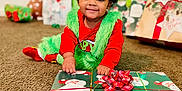 Legend is registered to the contest to win money with this photo: blackhair, child, christmas, face, female, festival, girl, hair, happy, head, openingpresent, person, photography, portrait, sitting, smile, toy