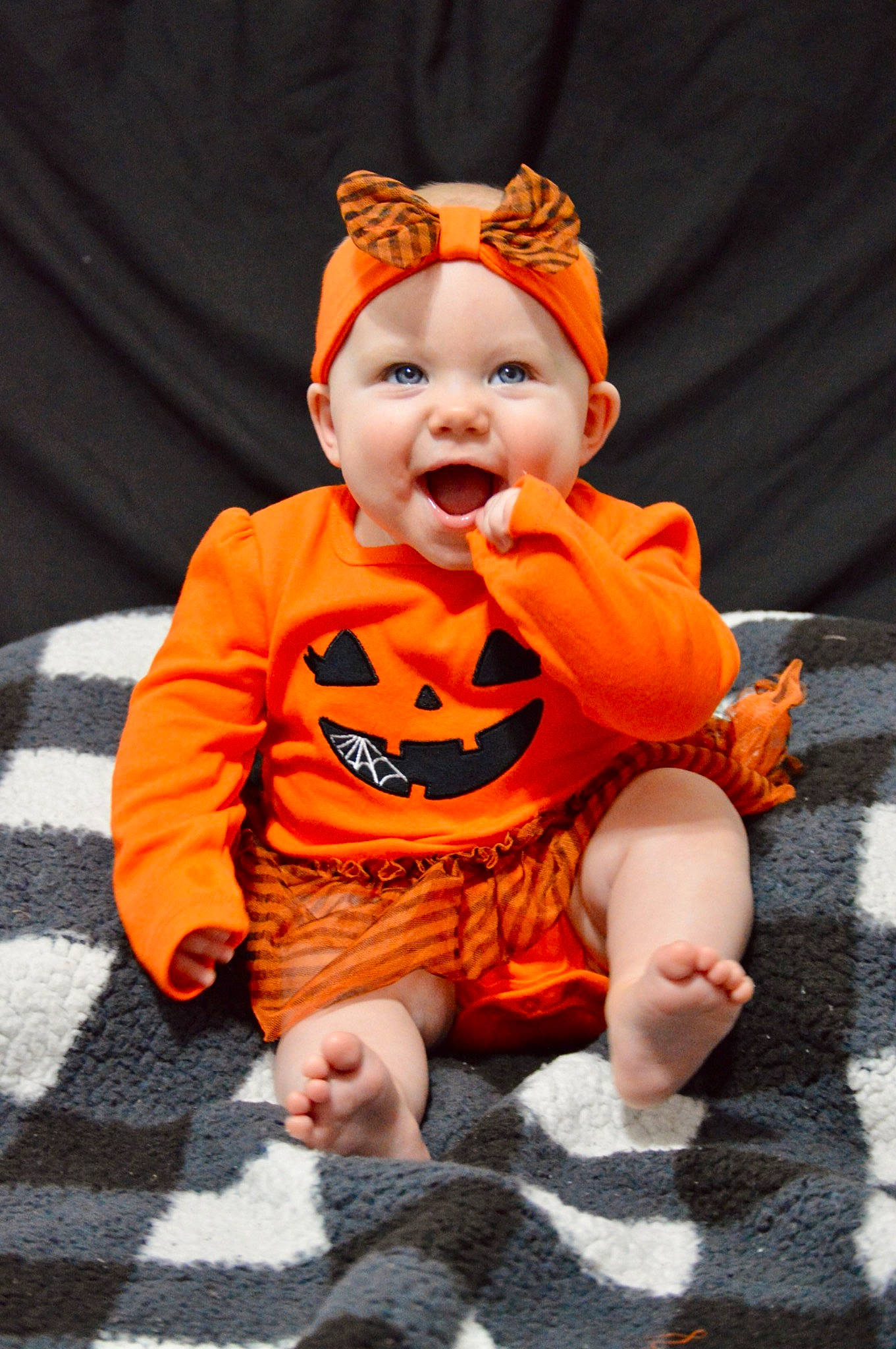 Kolbie is registered to the contest to win money with this photo: baby, baby_toddler_clothing, calabaza, child, eye, face, flooring, fun, happy, hat, head, headwear, human_body, leg, orange, peach, person, plant, sleeve, smile