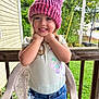 child, girl, smiling, hat, knitted_hat, pink, shorts, denim, butterfly_print, shirt, outdoor, porch, chair, wood, greenery, grass, happy, person, cute, summer