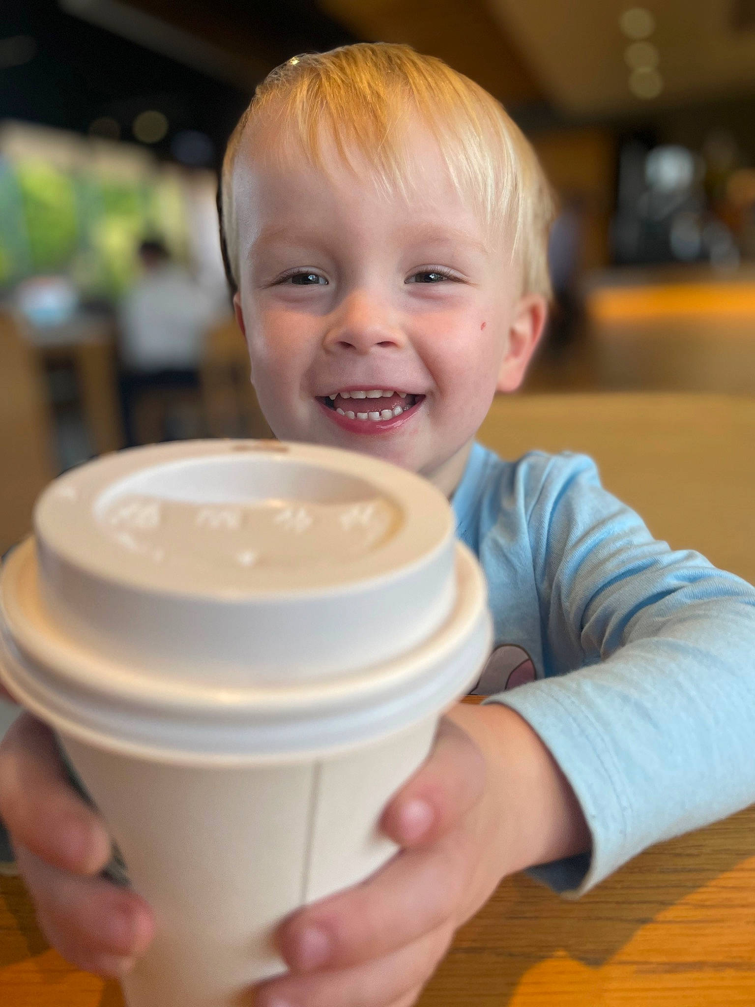 Archie is registered to the contest to win money with this photo: baby, baby_food, baby_toddler_clothing, cheek, child, drink, drinkware, flooring, fun, hand, happy, hardwood, joy, lid, person, plastic, serveware, smile, t_shirt, tableware