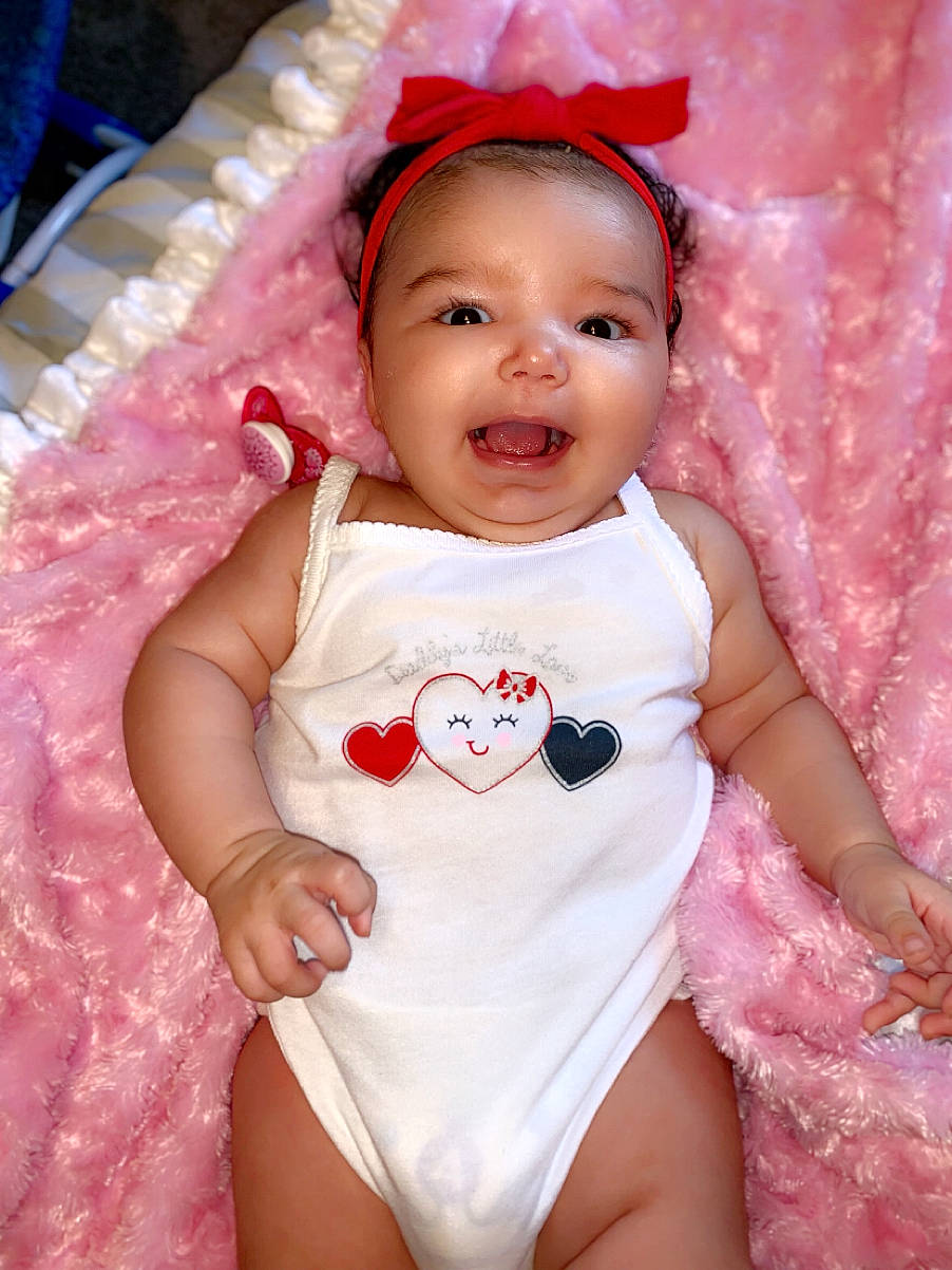 Kaidence is registered to the contest to win money with this photo: baby, baby_products, baby_toddler_clothing, cheek, child, hair_accessory, lip, person, pink, product, skin, smile, toddler