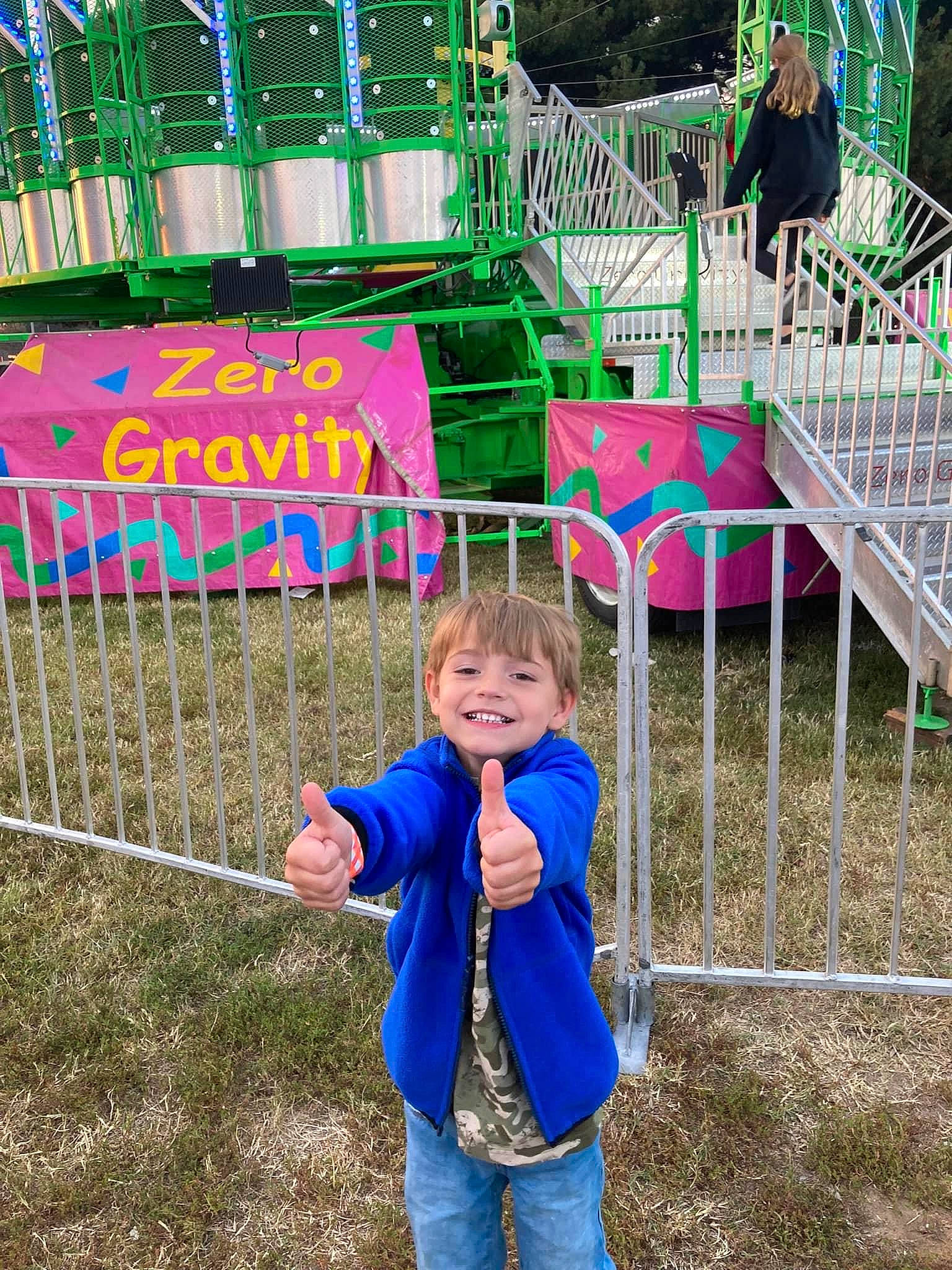 Hunter is registered to the contest to win money with this photo: chute, city, clothing, electric_blue, fun, grass, happy, human_settlement, joy, leisure, magenta, outdoor_play_equipment, person, plant, play, playground, public_space, recreation, sleeve, smile