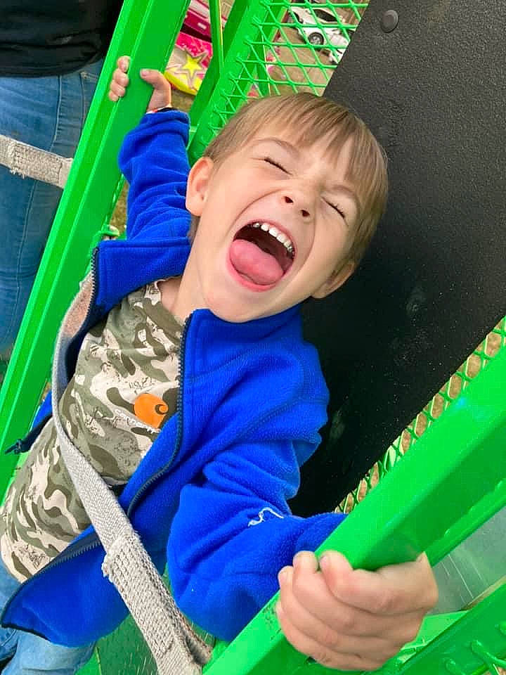 Hunter is registered to the contest to win money with this photo: baby, baby_laughing, baby_products, baby_toddler_clothing, child, electric_blue, fun, grass, green, happy, laugh, leisure, outdoor_play_equipment, person, play, playground, recreation, shout, sitting, smile