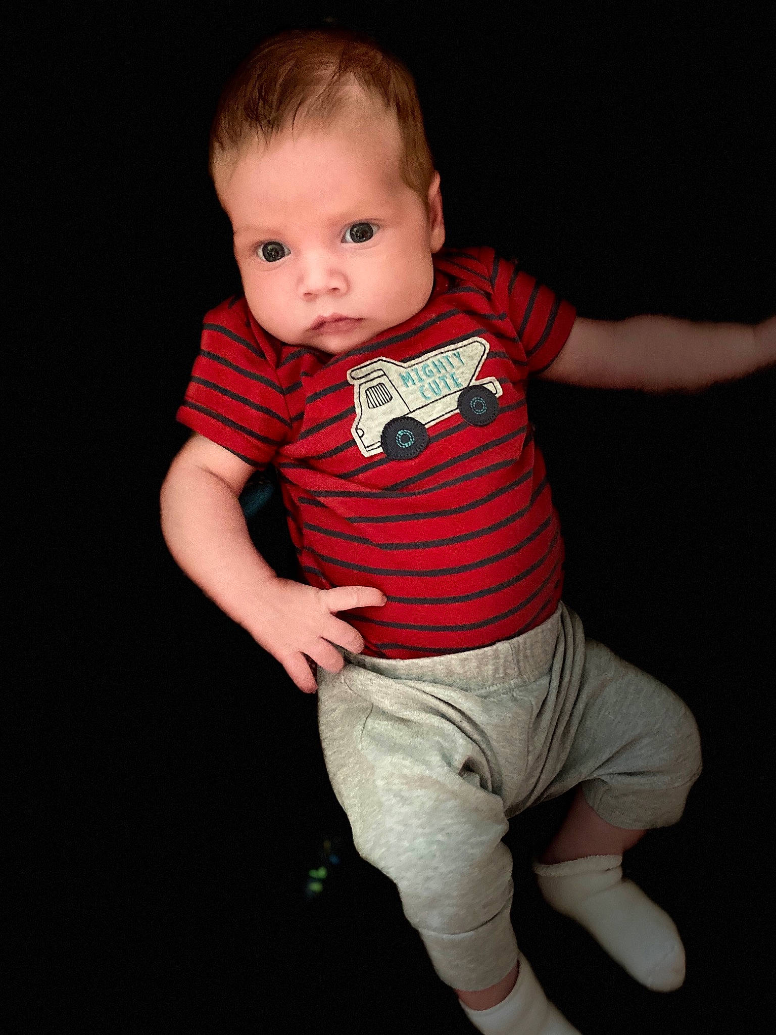 Luke is registered to the contest to win money with this photo: arm, baby, baby_toddler_clothing, cheek, child, child_model, fun, person, photography, product, red, sleeve, smile, standing, t_shirt, toddler