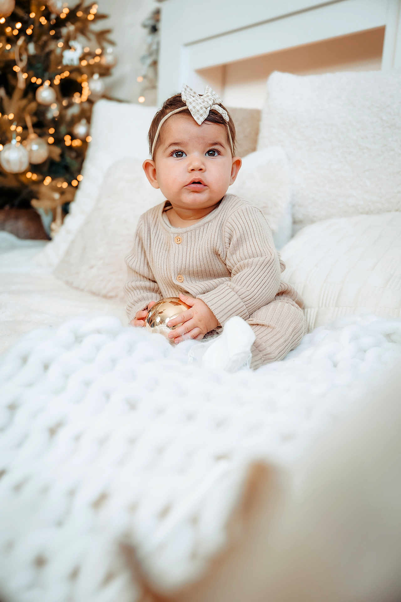 Soline a rejoint le concours — aidez-le/la à gagner de superbes lots ! baby, child, infant, face, headband, bow, ornament, christmas_tree, holiday, decorations, blanket, cozy, white, soft, cute, indoors, sitting, portrait, warm, festive