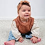 Soline participe au concours pour gagner de l'argent avec cette photo : baby, child, infant, sitting, carpet, headband, bow, brown_vest, knitwear, smile, cute, indoors, soft_texture, happy, portrait, casual_clothing, barefoot, young, person, crawling_position