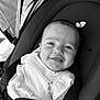baby, car_seat, smiling, child, face, infant, seatbelt, clothing, black_and_white, portrait, cute, safety, baby_clothes, closeup, young_child, happy, straps, seat, person, indoor