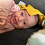 Celeste a rejoint le concours — aidez-le/la à gagner de superbes lots ! baby, infant, smile, face, pink_clothing, yellow_cloth, couch, teddy_bear, soft_toy, happy, cute, child, lying_down, indoors, close_up, human, skin, eyes, hand, cozy