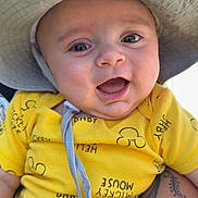 James joined the competition — help win amazing prizes! arm, baby, blue_sky, child, closeup, clothing, cute, daylight, expression, face, happy, hat, infant, mickey_mouse, outdoor, person, smiling, sunny, tattoo, yellow_shirt