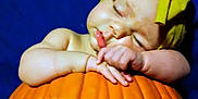 Alice joined the competition — help win amazing prizes! adorable, baby, blue_background, child, chubby_arms, close_up, cute, fall, holiday, infant, orange, peaceful, portrait, pumpkin, resting, seasonal, skin, sleeping, soft_light, yellow_headband