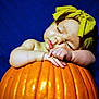 adorable, baby, blue_background, child, chubby_arms, close_up, cute, fall, holiday, infant, orange, peaceful, portrait, pumpkin, resting, seasonal, skin, sleeping, soft_light, yellow_headband