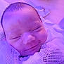 baby, infant, sleeping, smiling, face, head, mesh_blanket, soft_texture, purple_light, closeup, peaceful, newborn, skin, wrapped, portrait, indoors, cute, small, child, resting