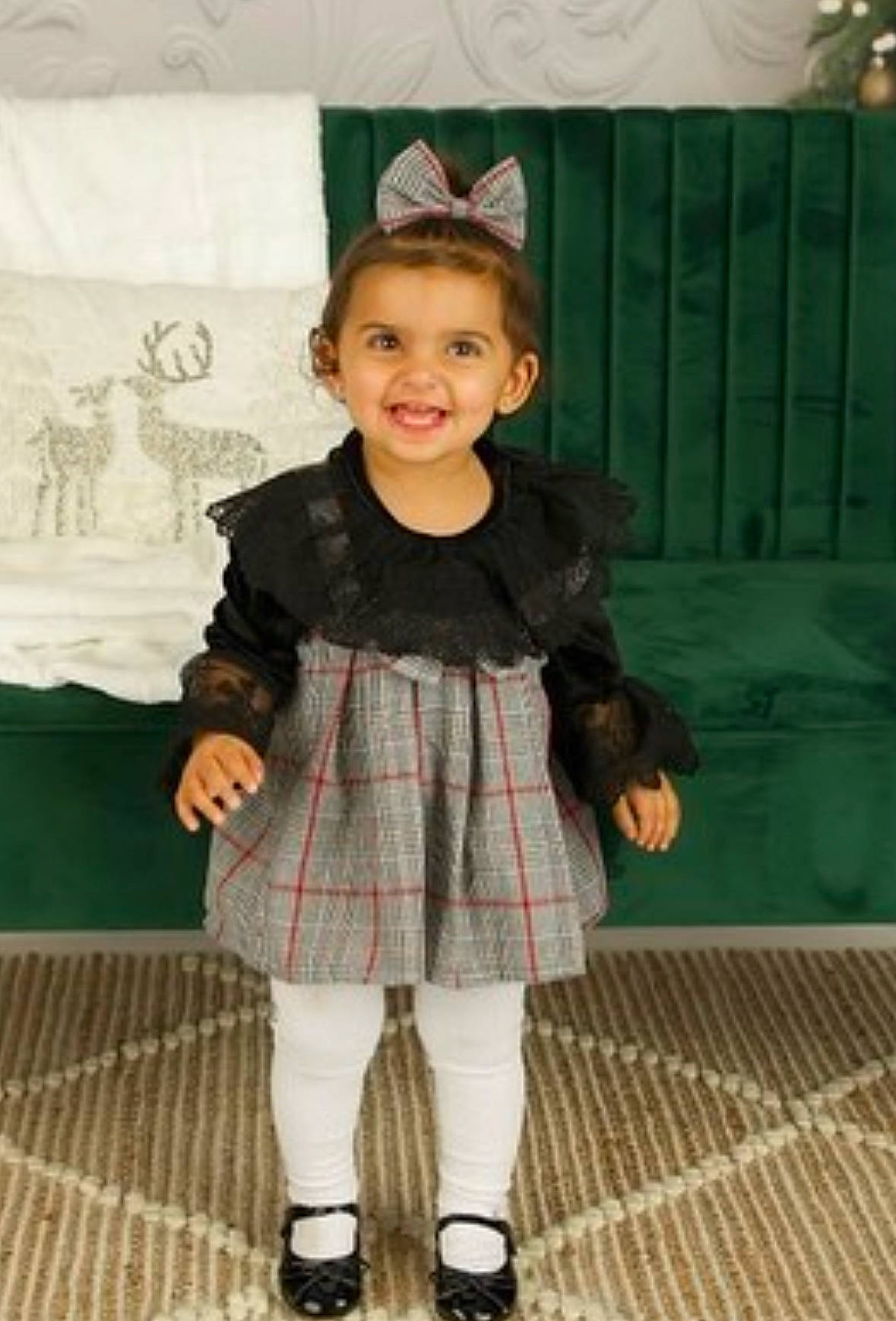 Athena is registered to the contest to win money with this photo: baby_toddler_clothing, child, dress, event, eye, fashion_accessory, fashion_design, flooring, fun, happy, joy, knee, leg, pattern, person, plaid, sleeve, smile, sock, tartan