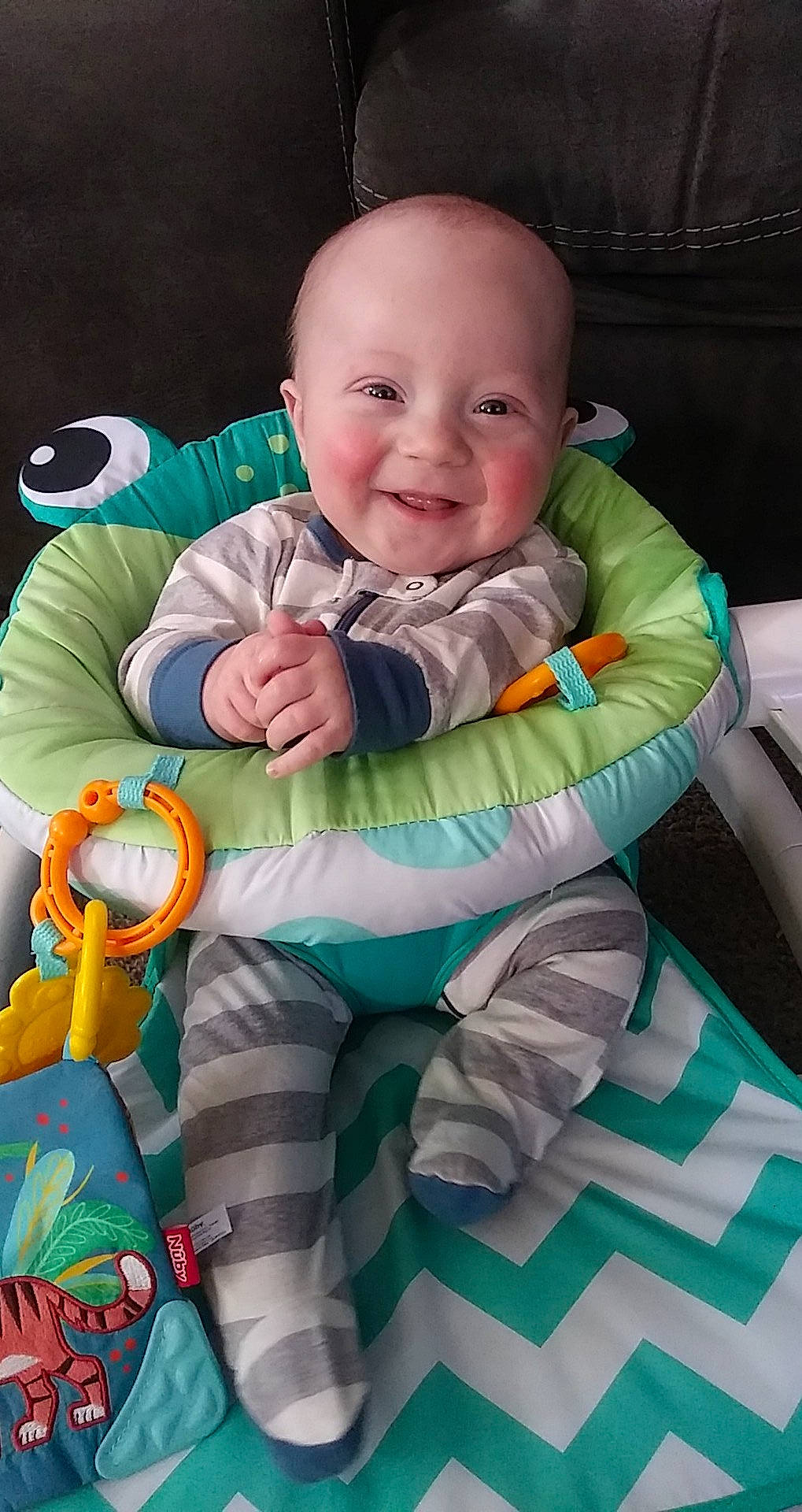 Xzavier is registered to the contest to win money with this photo: arm, baby, baby_products, baby_safety, baby_toddler_clothing, baby_toys, cheek, child, comfort, face, fun, grass, happy, joy, person, product, sitting, skin, sleeve, smile
