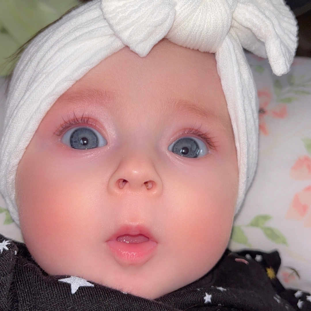 Clementine Grace is registered to the contest to win money with this photo: accessories, baby, beanie, bonnet, cap, clothing, coat, couch, face, furniture, hat, head, headband, homedecor, linen, newborn, person, photography, portrait, turban