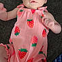 Eliana joined the competition — help win amazing prizes! baby, infant, child, pink_outfit, strawberry_pattern, lying_down, curious_expression, soft_skin, close_up, cute, person, small_hands, small_feet, indoors, carpet, fabric, colorful, young_child, portrait, casual