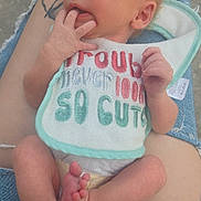 Eliana joined the competition — help win amazing prizes! newborn, baby, infant, bib, fingers, feet, diaper, tattoo, jeans, ripped_jeans, person, lap, footwear, casual_shoes, skin, hand, cute, relaxing, outdoor, closeup