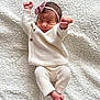 baby, newborn, infant, sleeping, white_clothing, knitwear, headband, pink_bow, blanket, soft_texture, cute, peaceful, lying_down, tiny_hands, tiny_feet, indoors, portrait, cozy, closeup, child