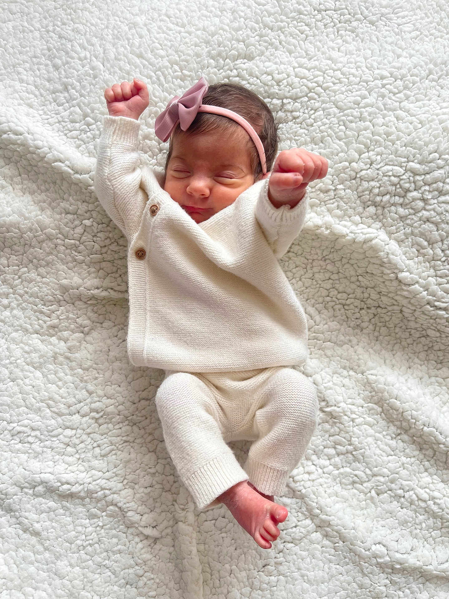 Kiara joined the competition — help win amazing prizes! baby, newborn, infant, sleeping, white_clothing, knitwear, headband, pink_bow, blanket, soft_texture, cute, peaceful, lying_down, tiny_hands, tiny_feet, indoors, portrait, cozy, closeup, child