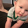 Alexander joined the competition — help win amazing prizes! baby, child, infant, face, arm, skin, clothing, person, closeup, indoor, adult, black_clothing, gray_shirt, green_trim, cute, chubby, portrait, human, young, casual