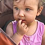 toddler, child, face, finger, pink_clothing, curious, portrait, closeup, baby, cute, expression, skin, hair, eyes, hand, seat, stroller, outdoor, soft_light, casual