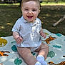 baby, child, smiling, outdoor, blanket, animal_print, grass, socks, shirt, happy, sitting, face, nature, cute, portrait, infant, sunlight, park, playful, young