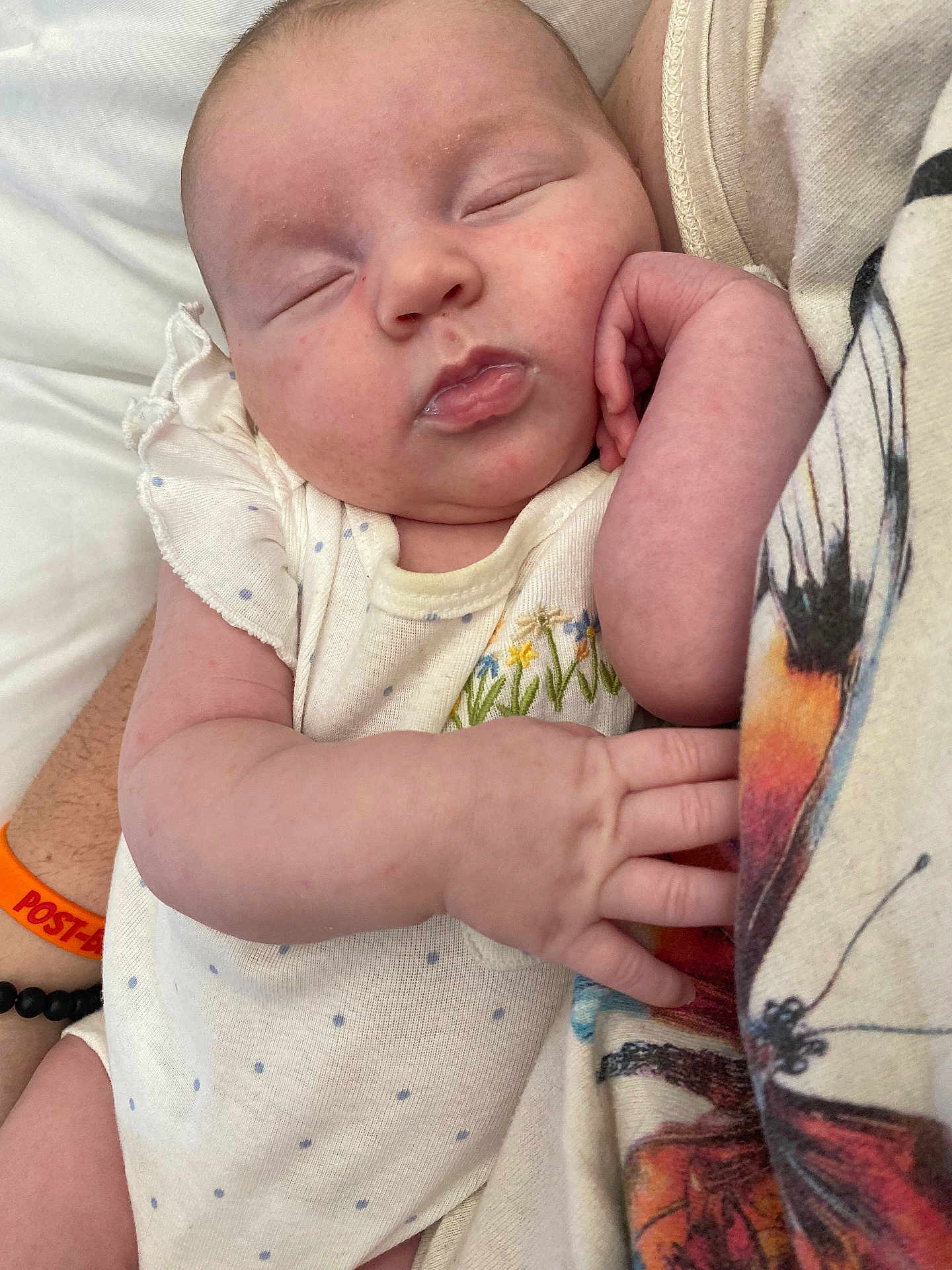 Everly is registered to the contest to win money with this photo: baby, butterfly, child, closeup, clothing, comfort, cute, face, floral_embroidery, hand, infant, patterned_fabric, peaceful, person, polka_dots, resting, sleeping, soft_skin, toddler, white_outfit