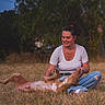Kyoto a rejoint le concours — aidez-le/la à gagner de superbes lots ! animal, casual_clothing, dog, field, golden_hour, grass, jeans, nature, outdoor, person, pet, photography, playing, portrait, rolling_over, sitting, smiling, sunset, trees, woman