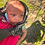 Zakhari is registered to the contest to win money with this photo: baby, infant, child, carrier, outdoor, grass, shadow, face, person, clothing, nature, sunlight, dirt, hand, pink, green, tree, wearing, portrait, young
