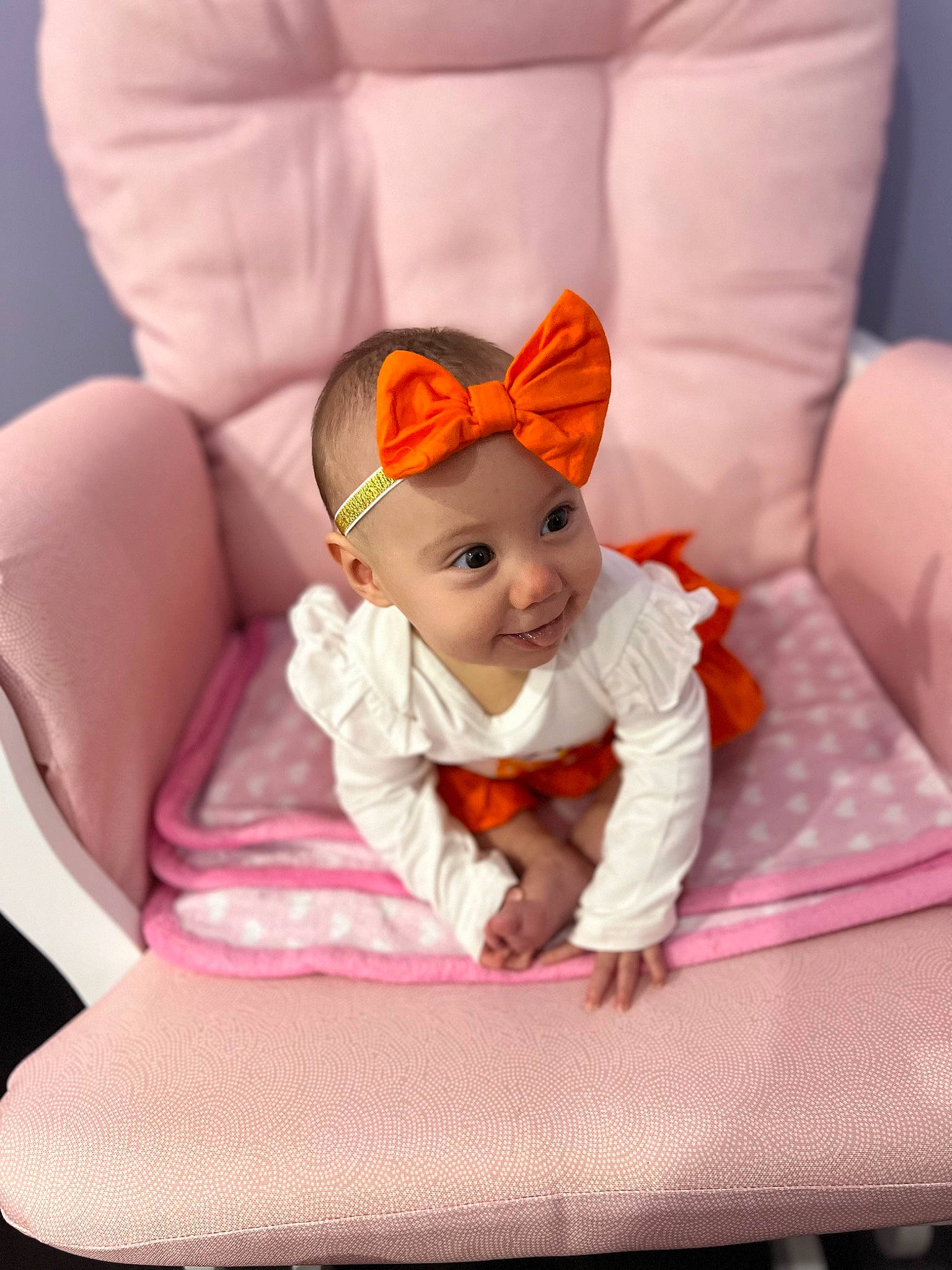 Dahlia joined the competition — help win amazing prizes! baby, baby_products, baby_toddler_clothing, comfort, costume_hat, couch, eye, fashion_accessory, happy, head, linens, magenta, person, pink, purple, room, sitting, smile, sock, toddler