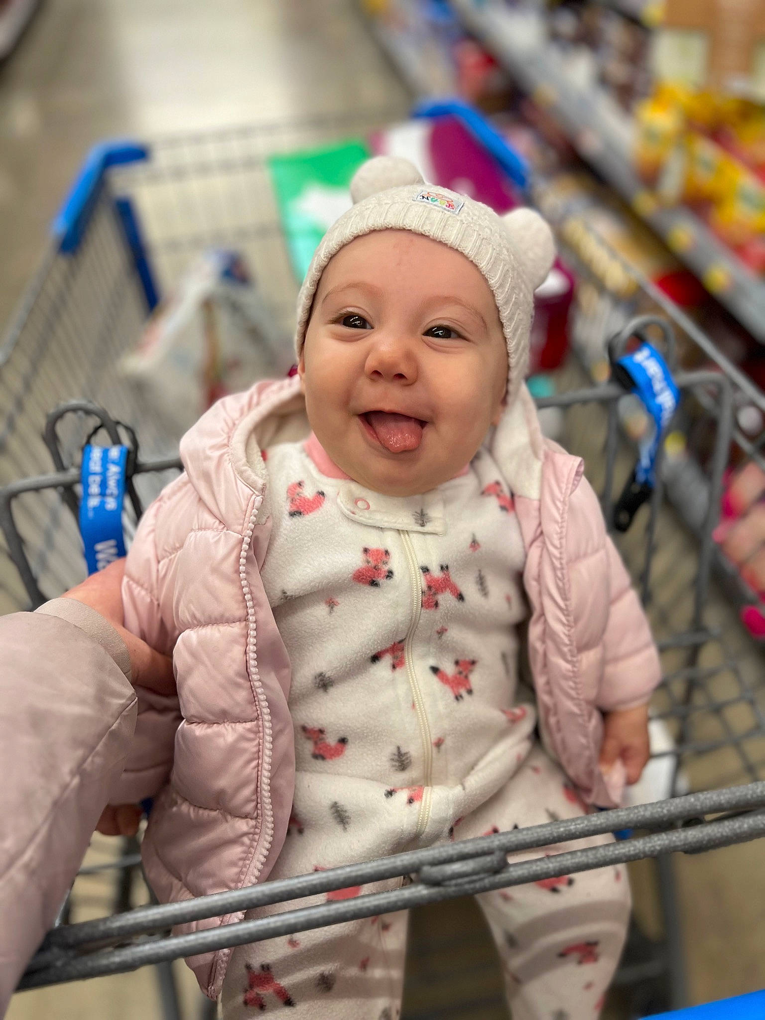 Dahlia is registered to the contest to win money with this photo: baby, baby_products, baby_toddler_clothing, blue, cap, cheek, child, city, eye, fun, happy, headwear, leisure, pattern, person, recreation, retail, skin, sleeve, smile