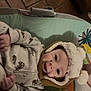 baby, infant, hat, pom_pom, smile, happy, clothing, baby_seat, cushion, pattern, floor, tile, indoor, child, cute, portrait, warm, cozy, person, expression