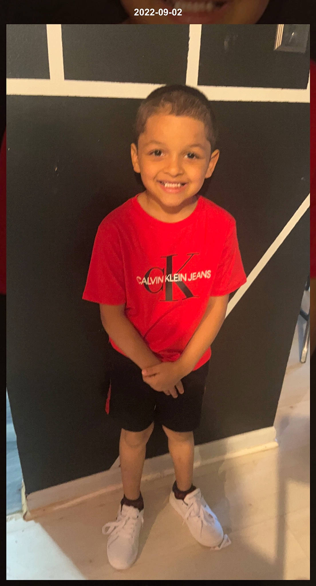 Cameron is registered to the contest to win money with this photo: active_shorts, cheek, chin, cool, floor, flooring, fun, happy, human_leg, joint, joy, knee, person, shorts, sleeve, smile, sneakers, sportswear, t_shirt, thigh