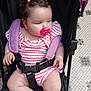 baby, pacifier, stroller, child, infant, pink, patterned_clothing, toddler, seatbelt, hair_ties, curly_hair, indoor, floor_tiles, plump_legs, cute, small_hands, looking_away, sitting, casual, comfort