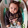 baby, infant, child, blue_eyes, pigtails, hair_ties, sweater, love_text, baby_bottle, baby_seat, cushion, comfort, cute, chubby_cheeks, indoor, portrait, clothing, hand, pink, toy
