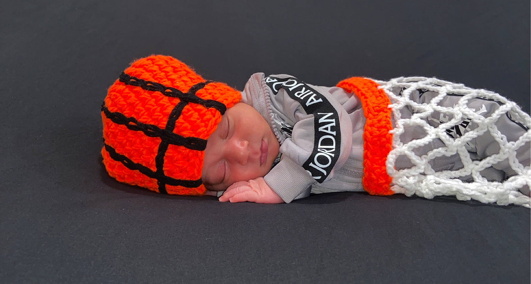 Dior is registered to the contest to win money with this photo: abdomen, ball, calabaza, carmine, fashion_accessory, flesh, font, glove, gourd, headwear, human_leg, linens, orange, pattern, person, personal_protective_equipment, sleeve, sports_gear, sportswear, thigh