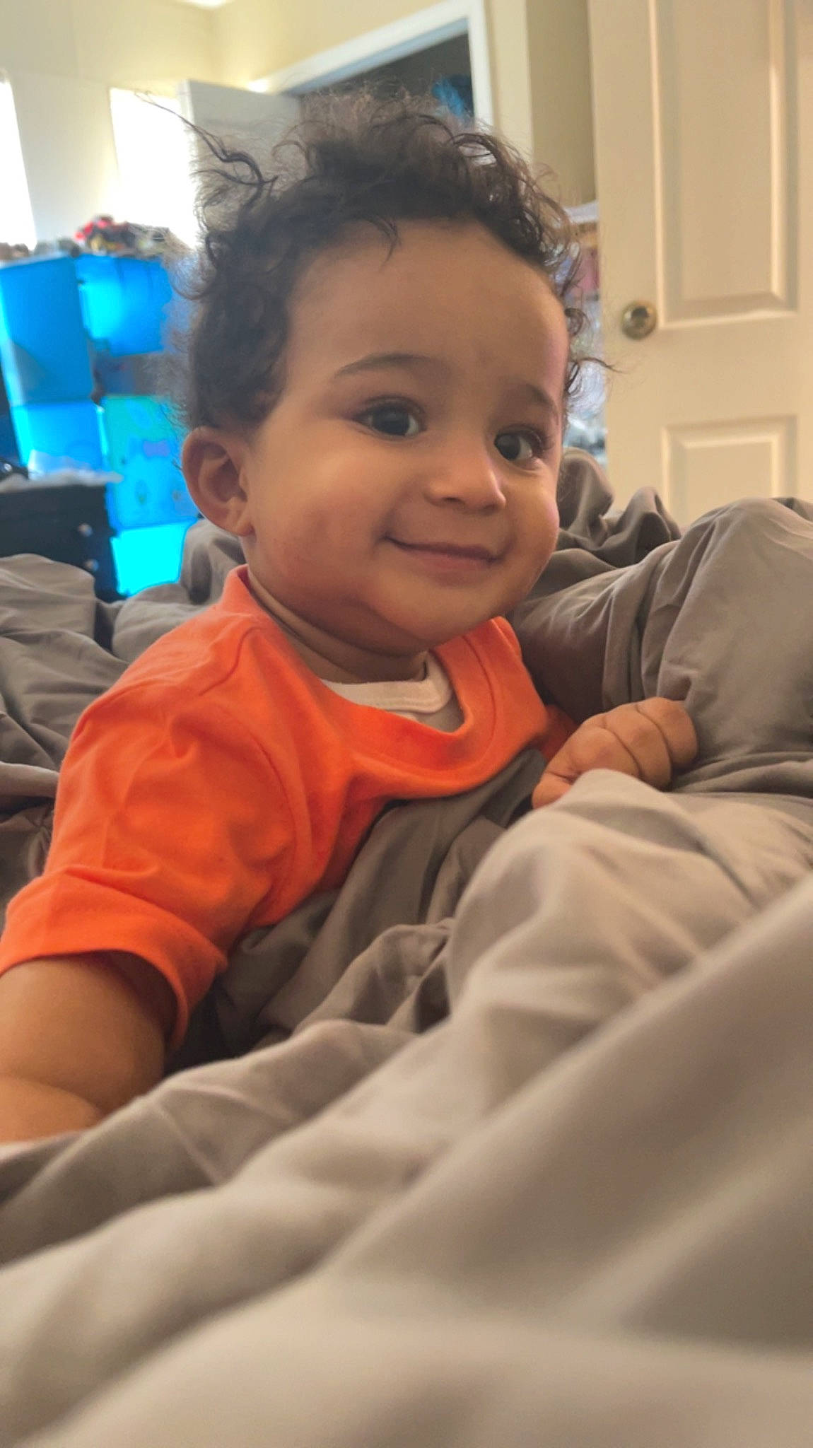 Dior is registered to the contest to win money with this photo: baby, cheek, comfort, door, eye, eyebrow, forehead, fun, gesture, happy, hearing, iris, joy, mouth, nose, person, sitting, skin, sleeve, smile